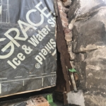 A brick wall with a sign that says grace ice water spa.