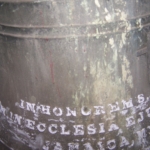 A bell with writing on it.