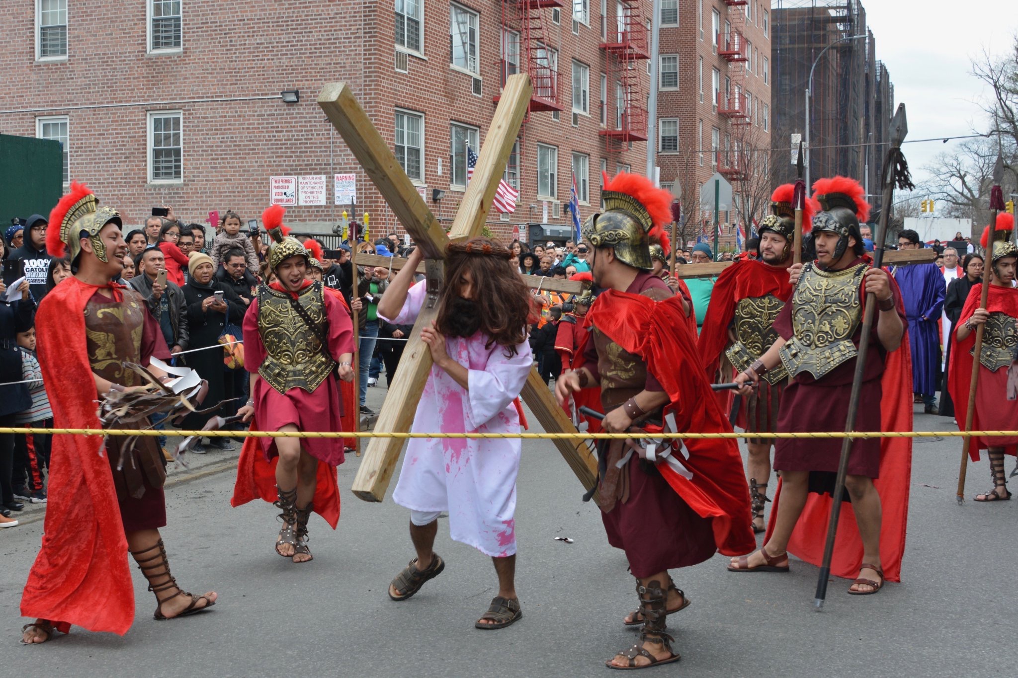 A group of people carrying a wooden cross.