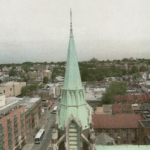 The spire of a church is green.