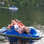 A group of people riding a jet ski on a lake.