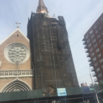 A church is under construction with scaffolding around it.