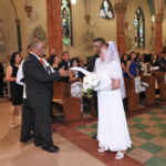 A bride and groom standing in a church.