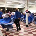 A group of mexican dancers in a room.