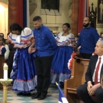 A group of people dressed in traditional mexican attire in a church.