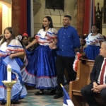A group of people dressed in traditional mexican attire in a church.