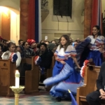 A group of people dressed in spanish costumes in a church.