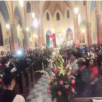 A crowd of people standing in a church.