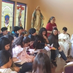 A group of young people sitting in a church.