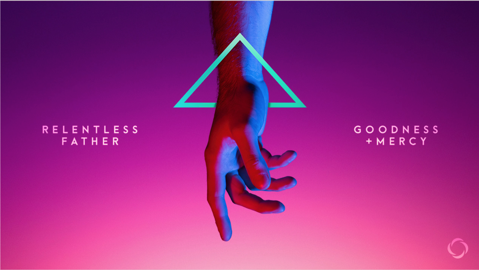 A hand holding a triangle with the words'relentless goodness father mercy'.