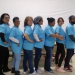 A group of people in blue shirts posing for a picture.