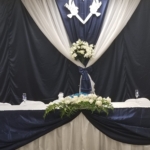 A wedding table decorated with blue and white flowers.