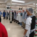 A group of people wearing aprons standing in a line.