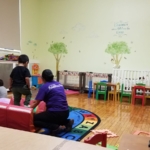 A group of children playing in a playroom.
