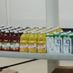 A table with several bottles of juice on it.