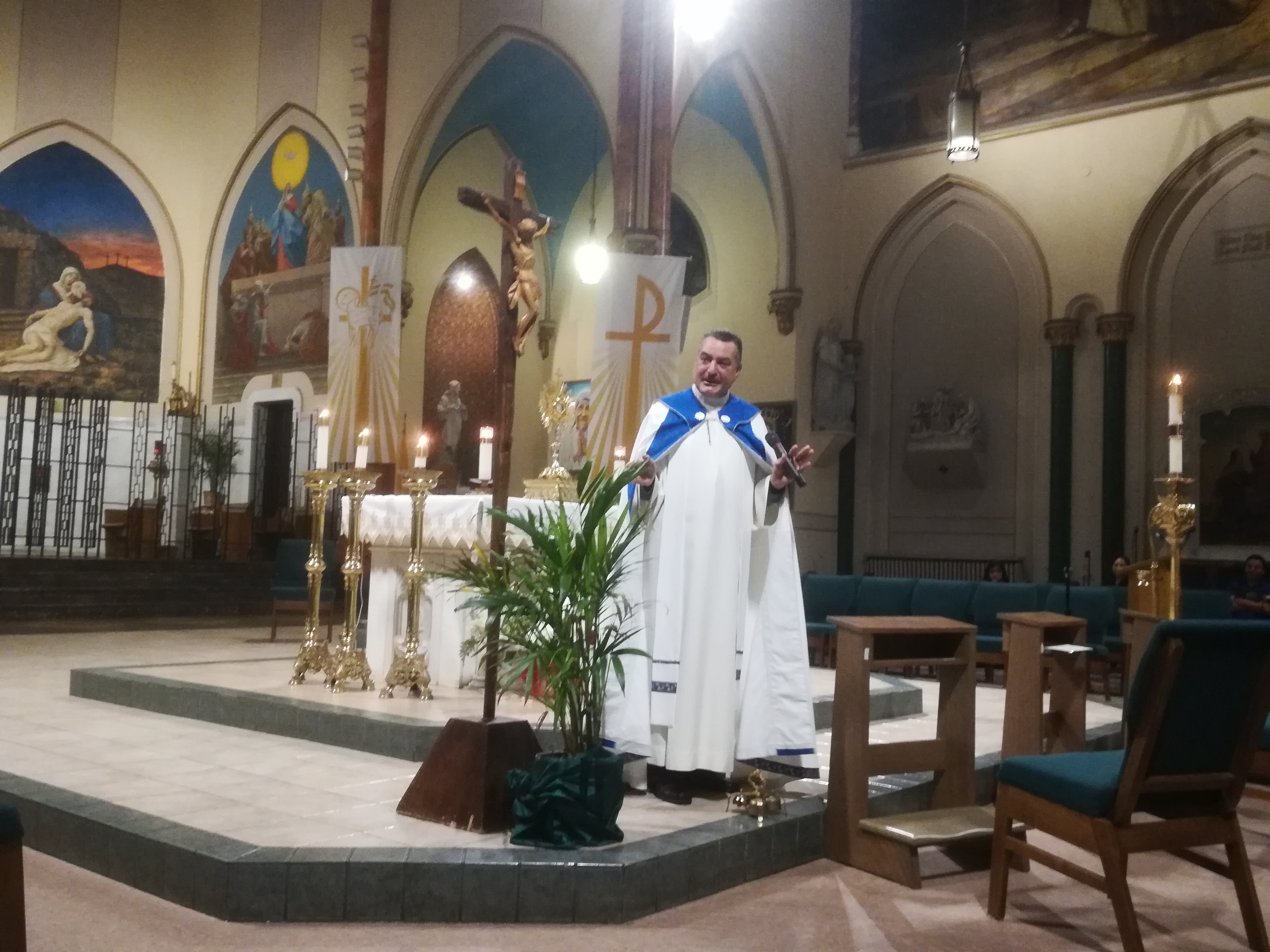 A priest standing in front of the altar.