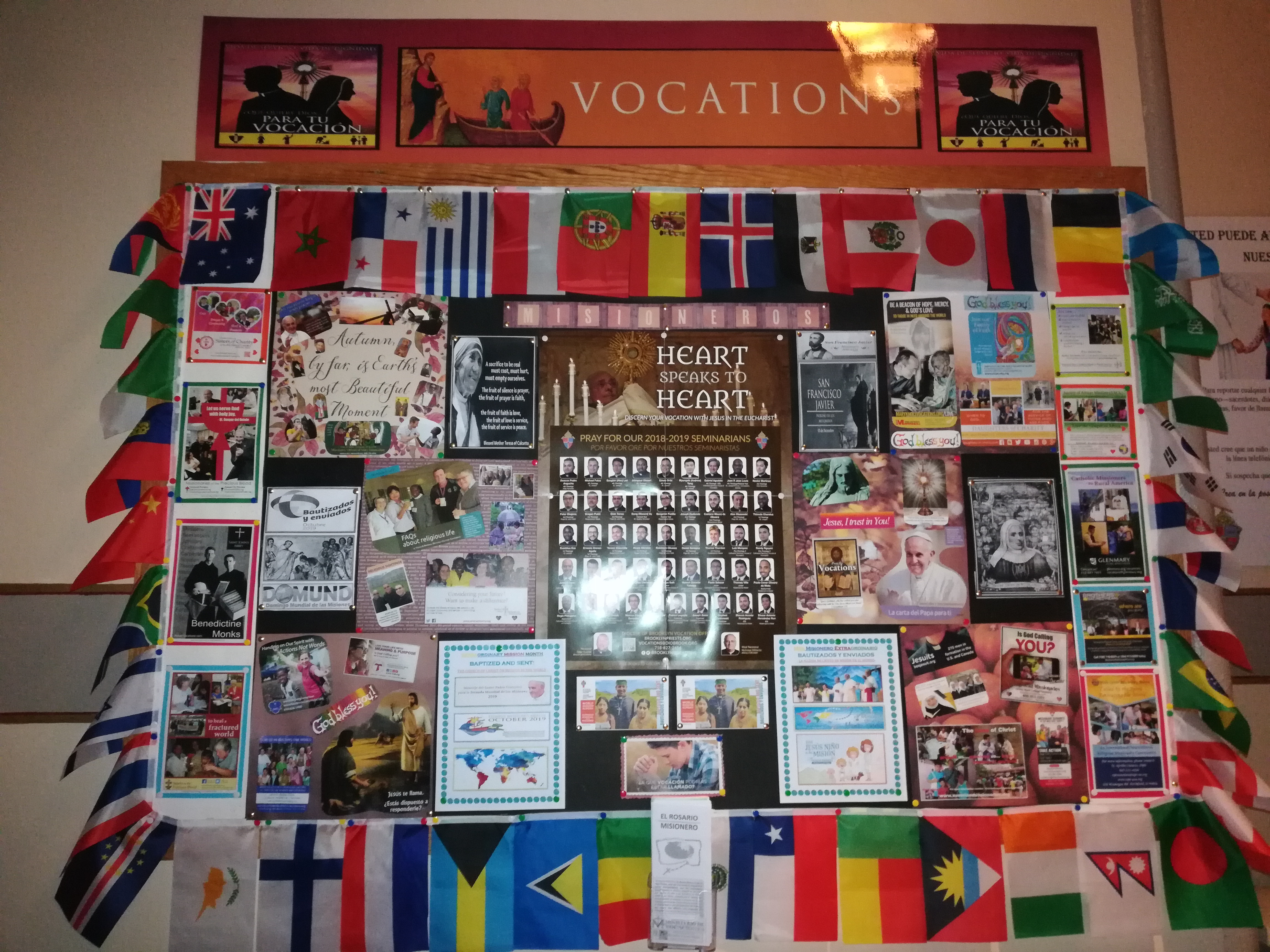A wall covered in many different flags and pictures.