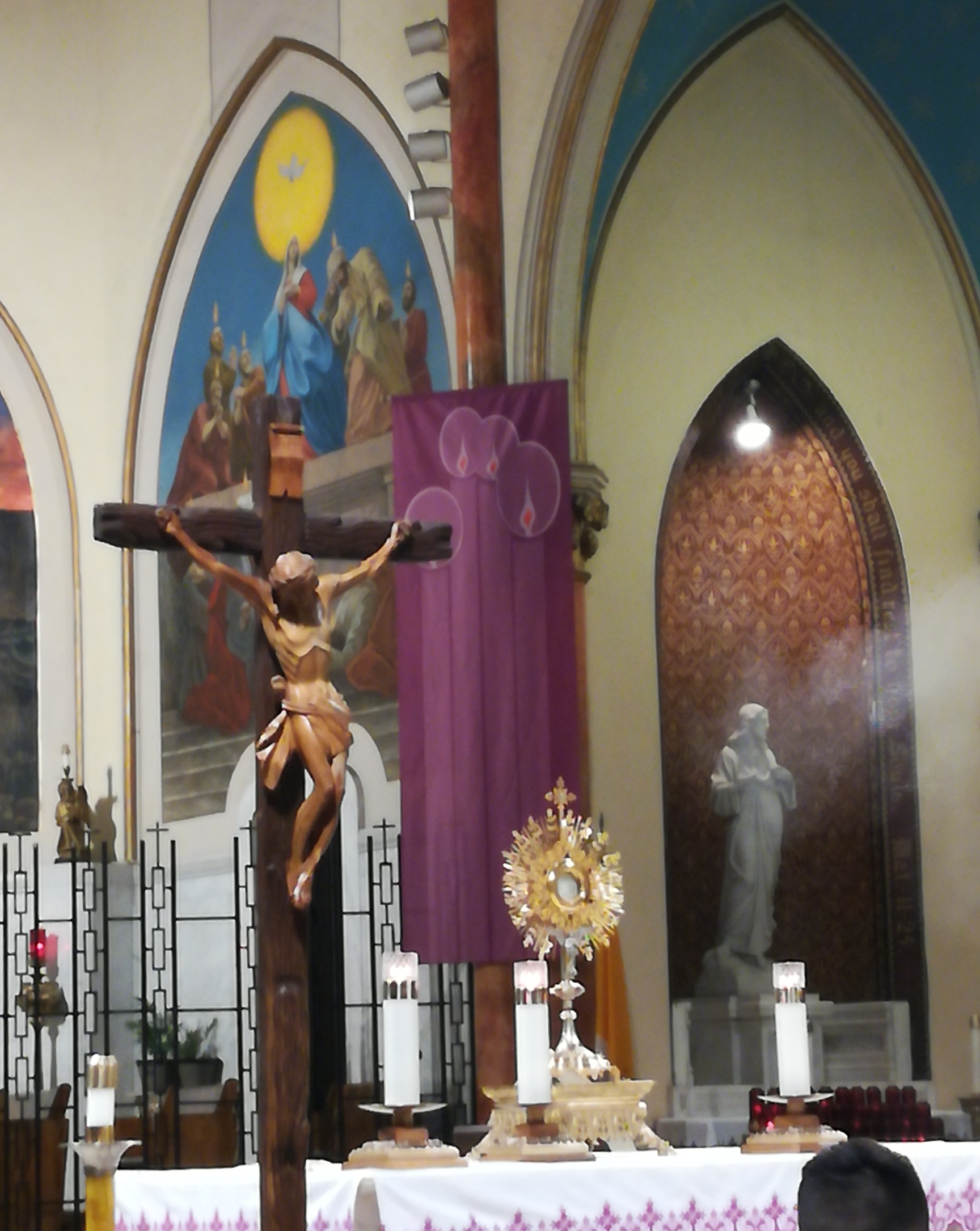 A cross and crucifix in the middle of a church.