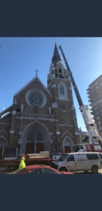 A crane is in front of the church.