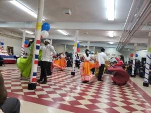 A group of people in costumes dancing inside
