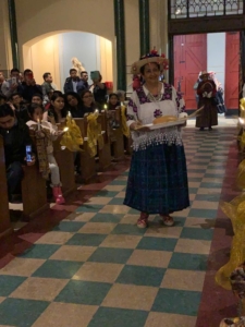 A woman in traditional clothing standing on the floor