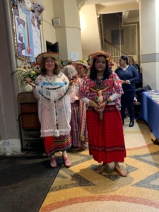 Two women in traditional mexican clothing standing next to each other.