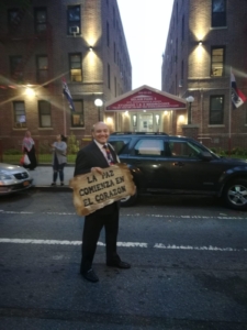 A man holding a sign in front of a building.