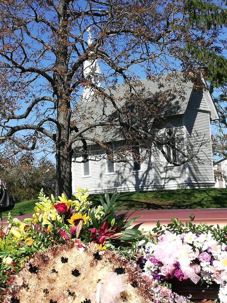 A church with flowers in front of it