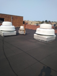 A roof with three different types of vents on it.
