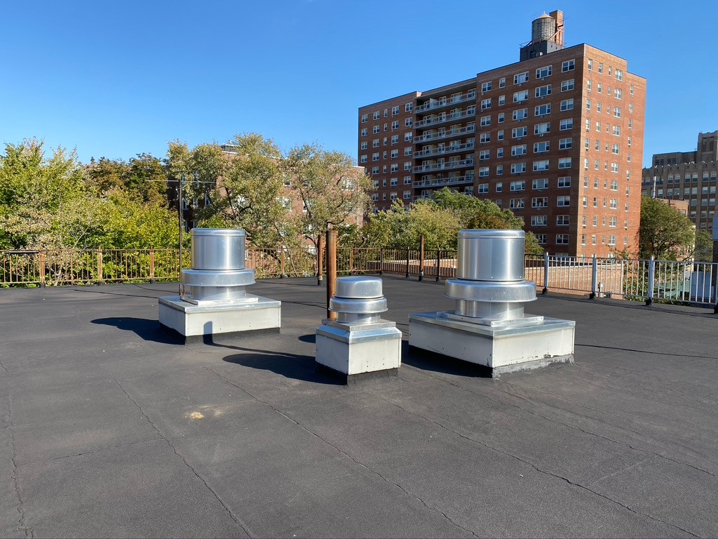 A group of three metal vents on the roof.