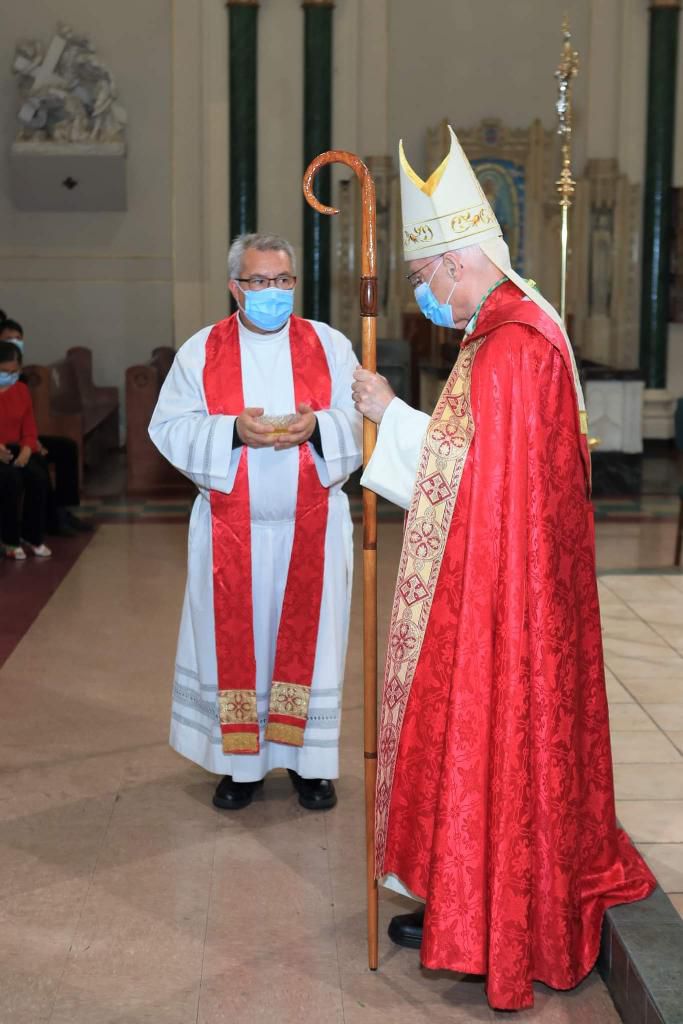 A priest and a man in red robes