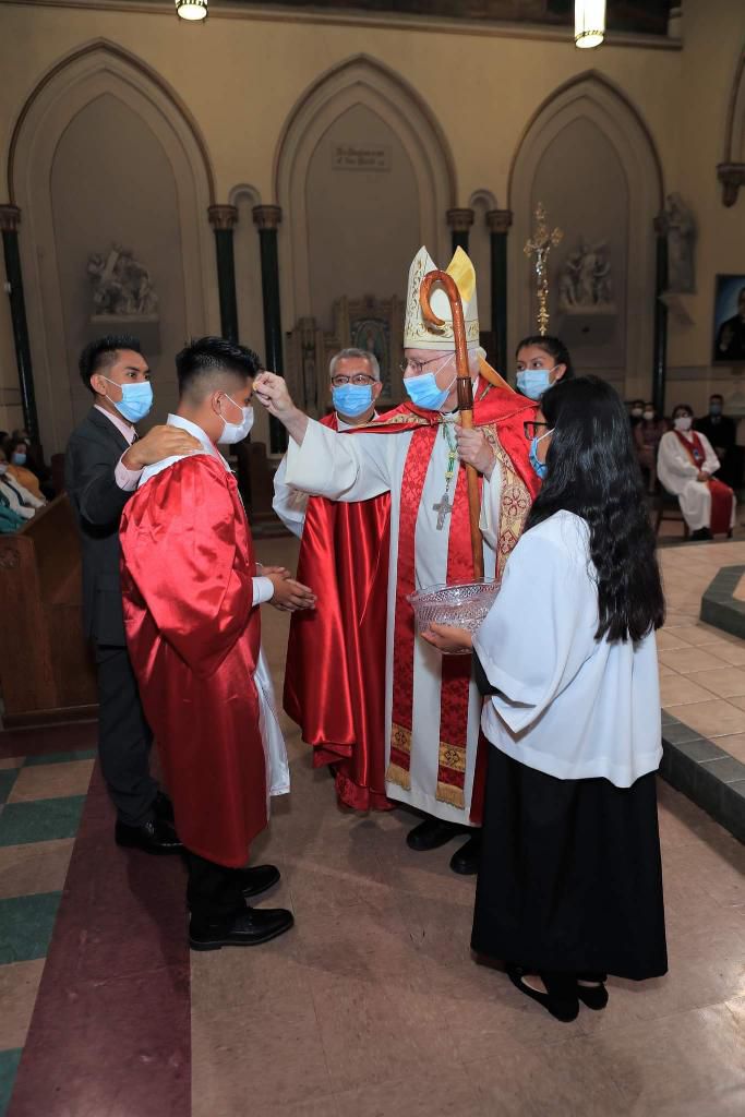 A group of people in church wearing masks.