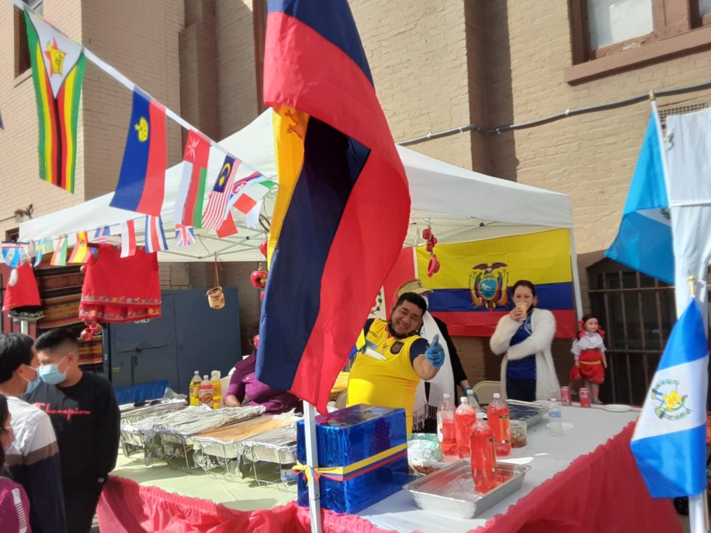 A man standing at the table with flags on it