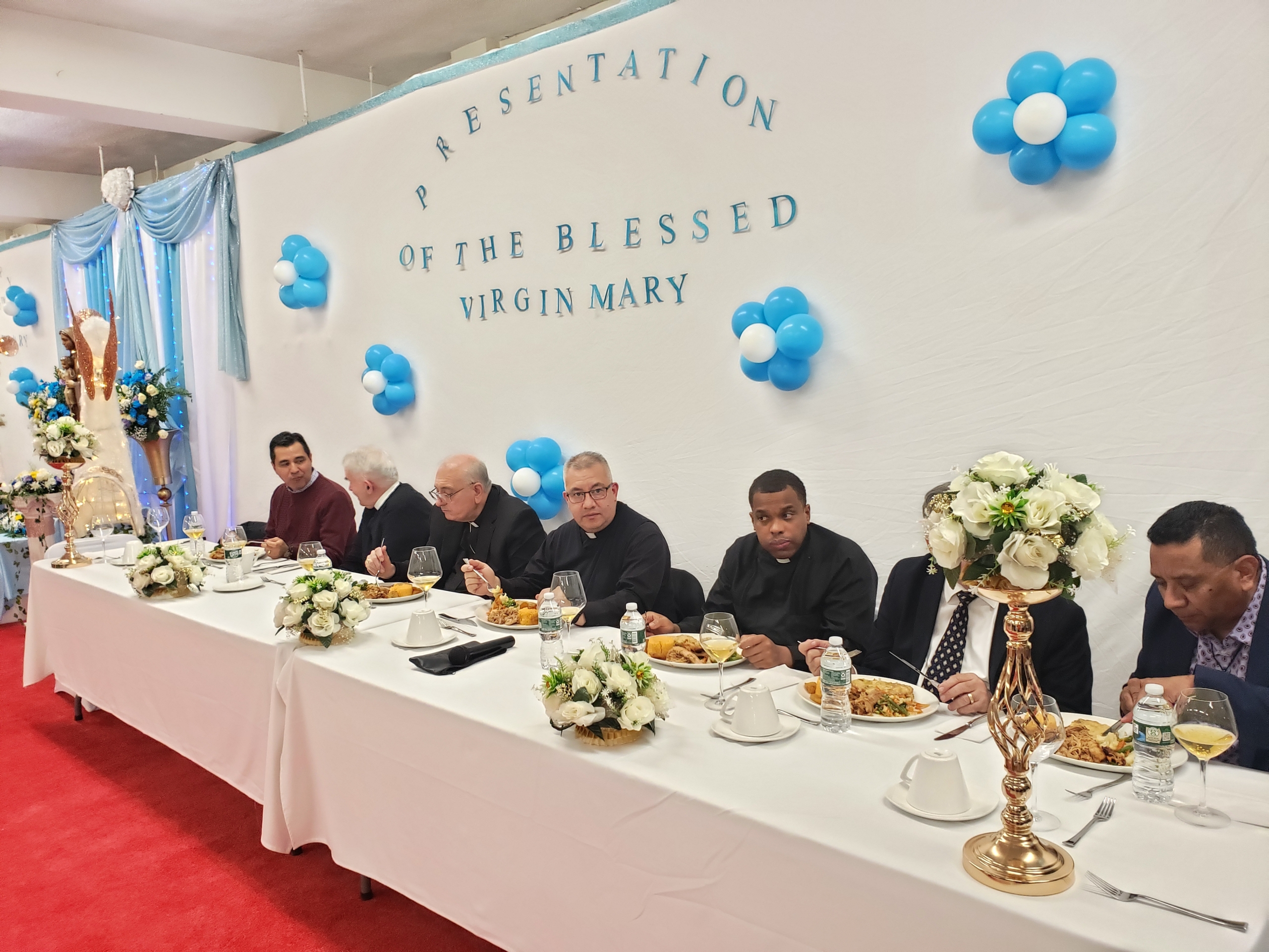 A group of people sitting at a long table.