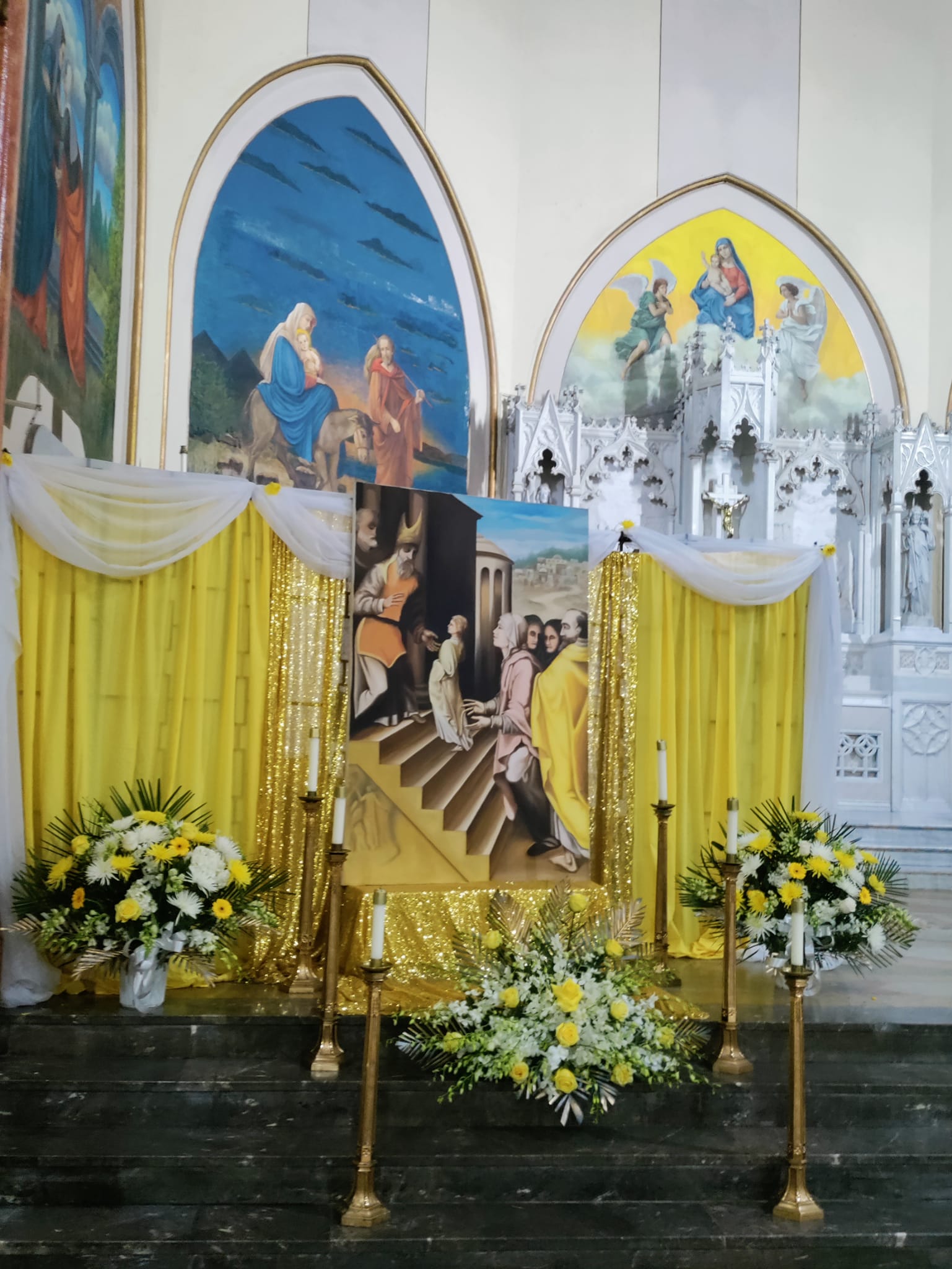 A painting of jesus is on display in front of the altar.
