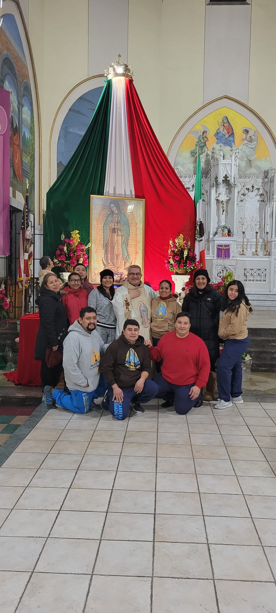 A group of people posing for a picture in front of an altar.
