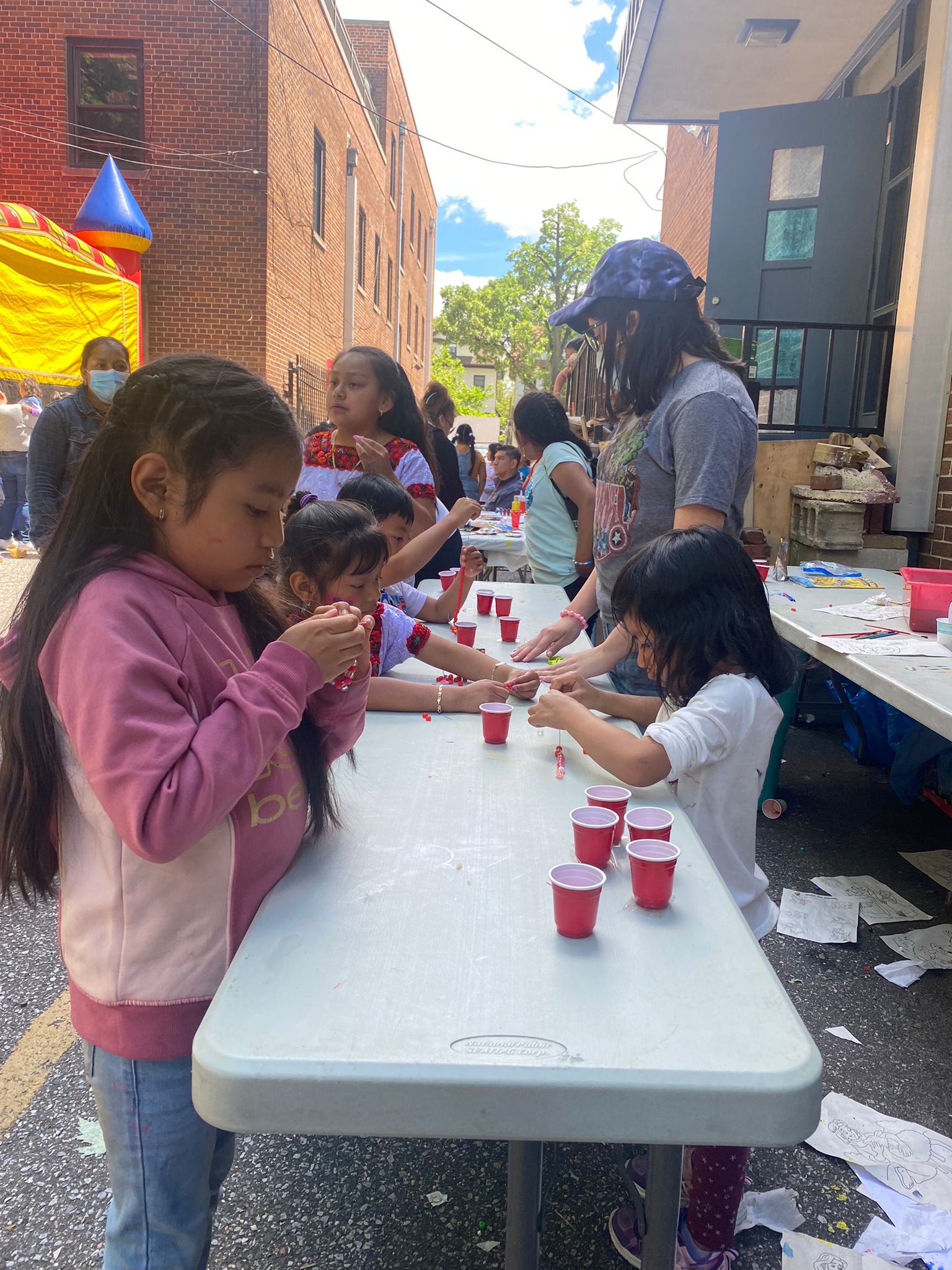 A group of children playing with cups on the table.